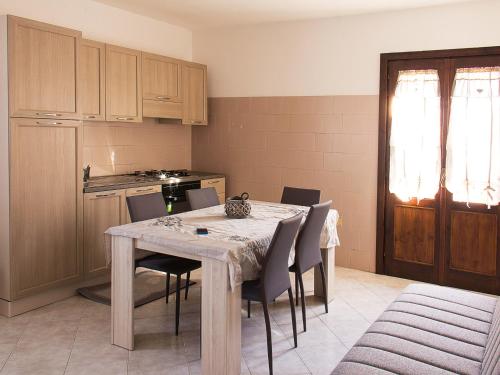 a kitchen with a table and chairs in a kitchen at Casa Vacanza Valledoria in Valledoria
