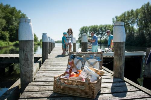 a basket of fruit sitting on a wooden pier at ´t Wapen van Marion in Oostvoorne