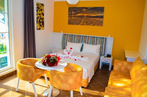 a hotel room with a bed and a table and chairs at Hotel Monaco & Garden in Golem