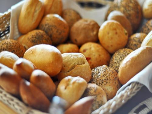 a basket filled with lots of different types of bread at Grand Hotel Palladium Santa Eulalia del Río in Santa Eularia des Riu