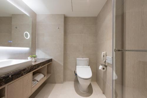a bathroom with a toilet and a sink at K Hotel Taipei Chang-An in Taipei