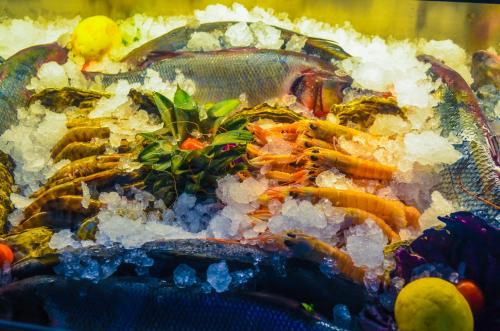 a plate of food with seafood and rice at Hotel Monaco & Garden in Golem