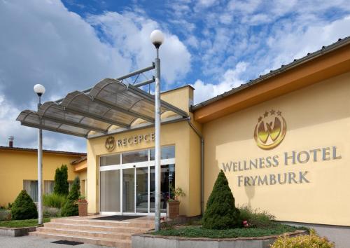 a building with a sign on the front of it at Wellness Hotel Frymburk in Frymburk
