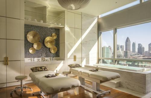 a room with two beds and a large window at Four Seasons Hotel Tianjin in Tianjin