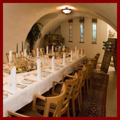 a long table in a room with chairs and white tables at Waldhotel Nachtigall in Paderborn