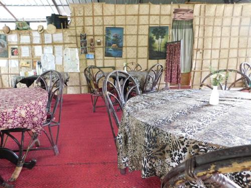 a dining room with tables and chairs in a room at Green Woods Bethlehem in Cochin