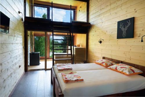 a bedroom with two beds in a room with windows at Pinus Villas Lodge with Private Jacuzzi & Phyto-Sauna Retreat in Zheleznitsa