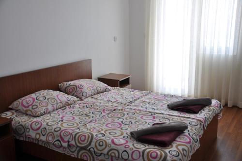 a bedroom with a bed with pillows on it at Akhmed Guest House in Kvariati