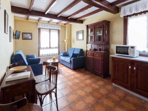 a living room with a couch and a table at As Tapias Apartamentos in Tapia de Casariego