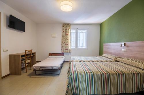 Postel nebo postele na pokoji v ubytování Hotel Blason Junior