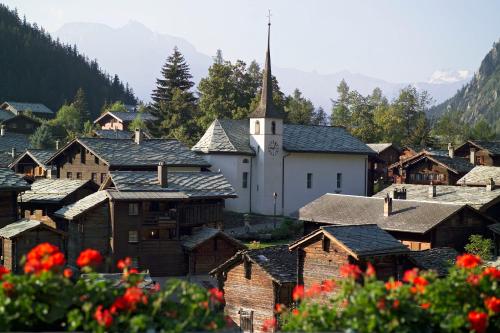 a small village with a church in the mountains at Danica in Blatten bei Naters
