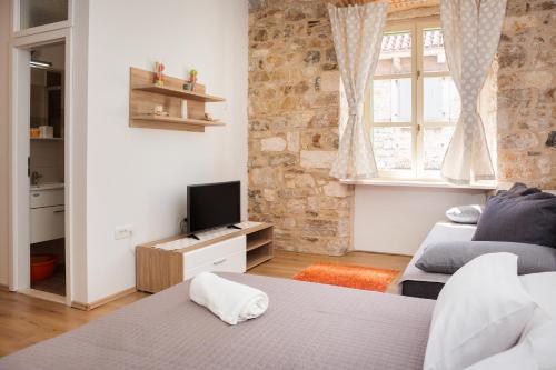 a living room with two beds and a television at Lux Cindro Studio in Split Center in Split