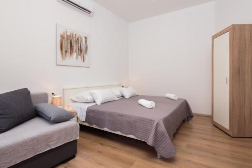 a bedroom with a bed and a couch at Lux Cindro Studio in Split Center in Split