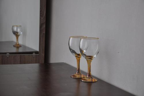 two wine glasses sitting on top of a table at Akhmed Guest House in Kvariati