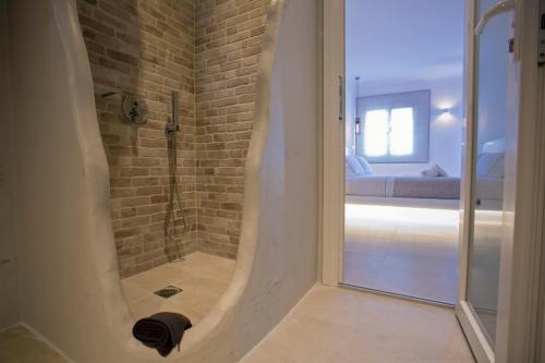 a bathroom with a shower with a glass door at Nida Mykonos in Mikonos