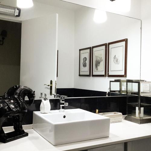 a bathroom with a white sink and a mirror at Kika room Estoril in Estoril