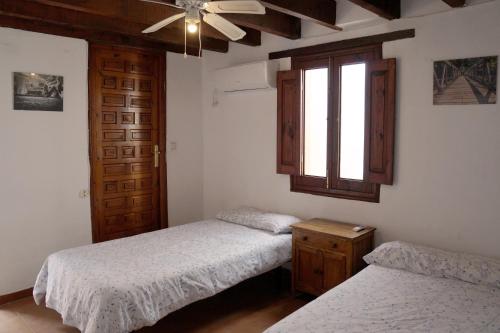 a bedroom with two twin beds and a window at Penthouse duplex in center in Seville