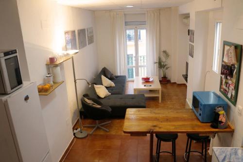 a living room with a couch and a table at Penthouse duplex in center in Seville