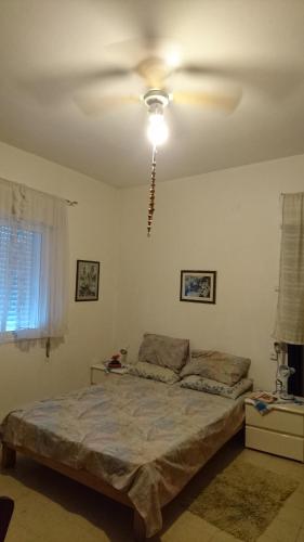 Ένα ή περισσότερα κρεβάτια σε δωμάτιο στο Stella Maris Hosting