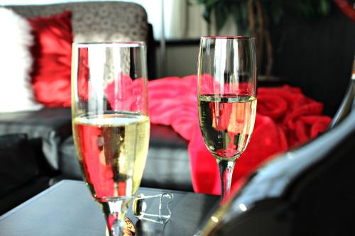 two glasses of champagne sitting on a table at Grand Times Hotel in Quebec City