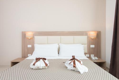 a bedroom with a bed with towels on it at Hotel St. Giorgio in Castel San Giorgio
