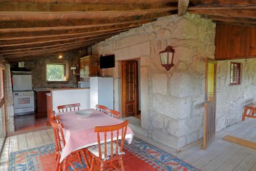 a kitchen and dining room with a table and chairs at Quinta do Galgo in Amares