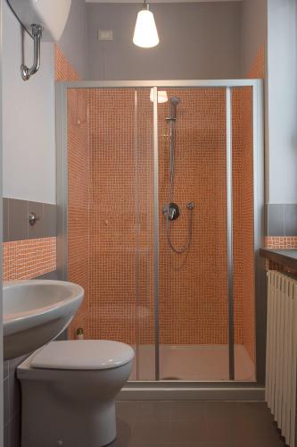 a bathroom with a shower with a toilet and a sink at B&B San Russorio in Pisa