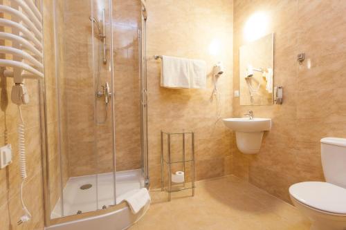 a bathroom with a shower and a toilet and a sink at Dom Studenta Nr 1 ANS w Koninie in Konin