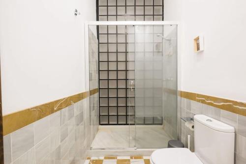 a bathroom with a glass shower with a toilet at Design Apartment in the city center in Málaga