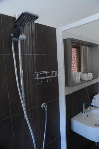 a bathroom with a shower and a sink at Hotel Astoria in Ravenna