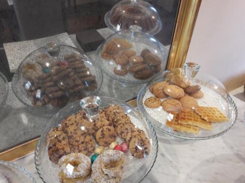 a table topped with plates of different types of pastries at Novecento in Anagni