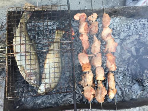 a bunch of food on a grill with a banana at Guest House Marani in Sighnaghi