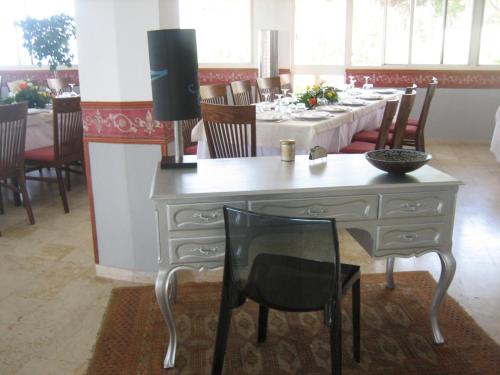 a dining room with a white table and chairs at Villa Dei Principi Hotel in Terracina