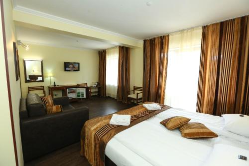 a hotel room with a bed and a couch at Home Hotel in Bukovel
