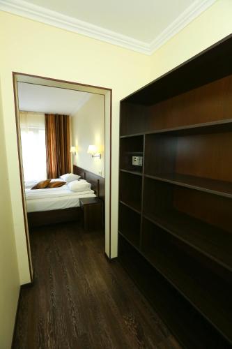 a hotel room with a bed and a mirror at Home Hotel in Bukovel