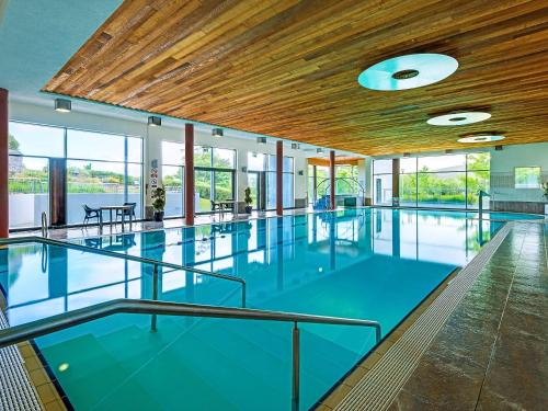 an empty swimming pool with blue floors and wood ceilings at Mulranny Park Hotel in Mulranny