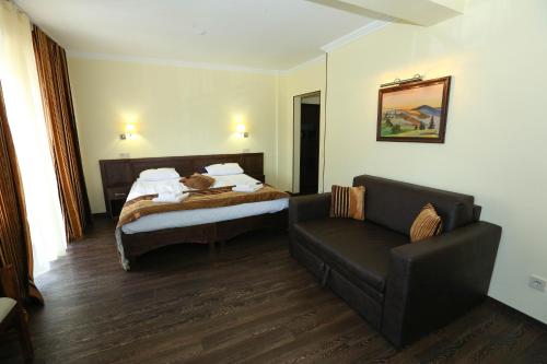 a hotel room with a bed and a couch at Home Hotel in Bukovel