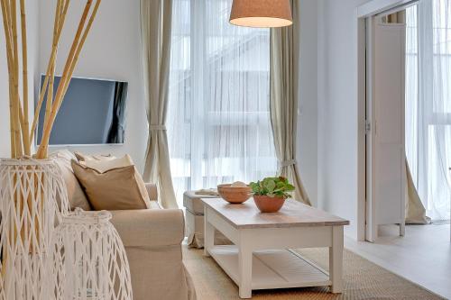a living room with a couch and a table at INA Rent - Tre Mare Apartamenty in Gdańsk