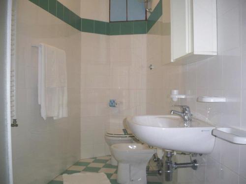a bathroom with a sink and a toilet at Hotel Residence La Fortezza in San Lucido