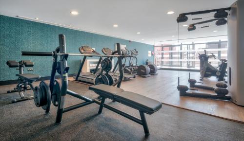 a gym with several tread machines in a room at Ilunion Calas de Conil in Conil de la Frontera