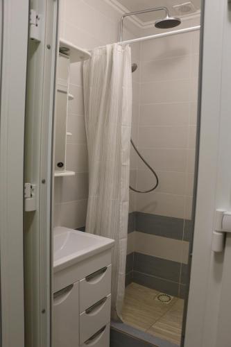 a bathroom with a shower curtain and a sink at Nadiira in Slavske