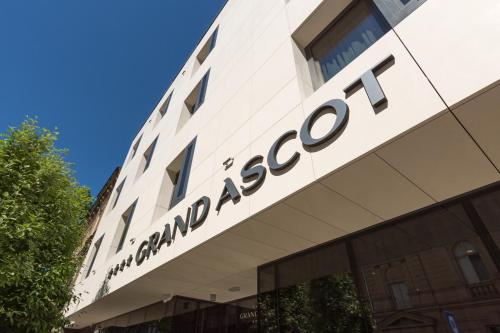 a sign on the side of a building at Grand Ascot Hotel in Kraków