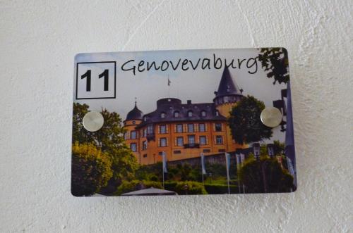 a sign hanging on a wall with a building at Gästehaus Am Hochsimmer in Ettringen