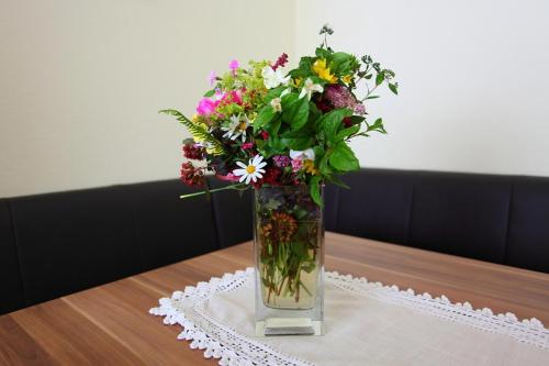 a vase filled with flowers sitting on a table at Appartements Wirnsperger in Grossarl