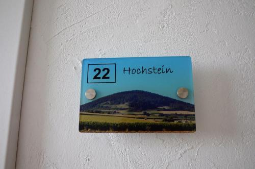 a lightswitch on a wall with a picture of a mountain at Gästehaus Am Hochsimmer in Ettringen