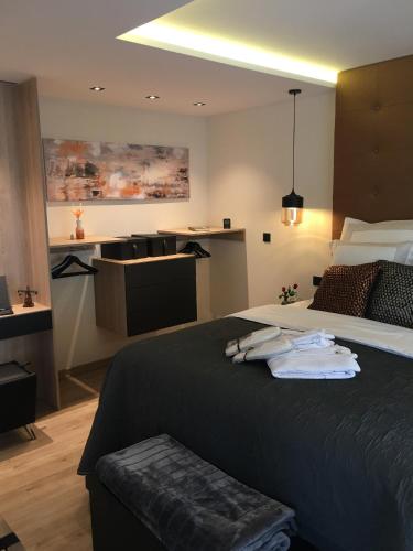 a hotel room with a large bed with towels on it at Moselapart in Cochem