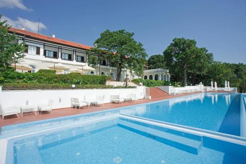 a large swimming pool with chairs and a building at HVD Boutique Hotel Oasis - Private Beach & Free Parking in Golden Sands