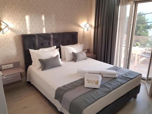 a bedroom with a large bed with white sheets and pillows at Deluxe Dina in Skala Potamias
