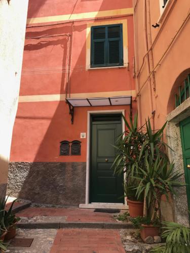 an orange and green building with a green door at Mi Va in Lerici