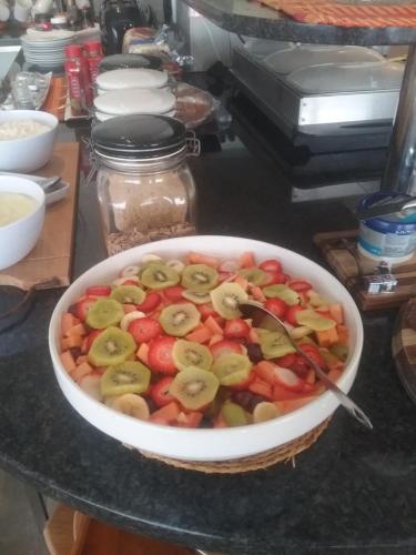 a bowl of fruit with bananas and strawberries on a table at Greenfire Umdloti Bed & Breakfast in Umdloti